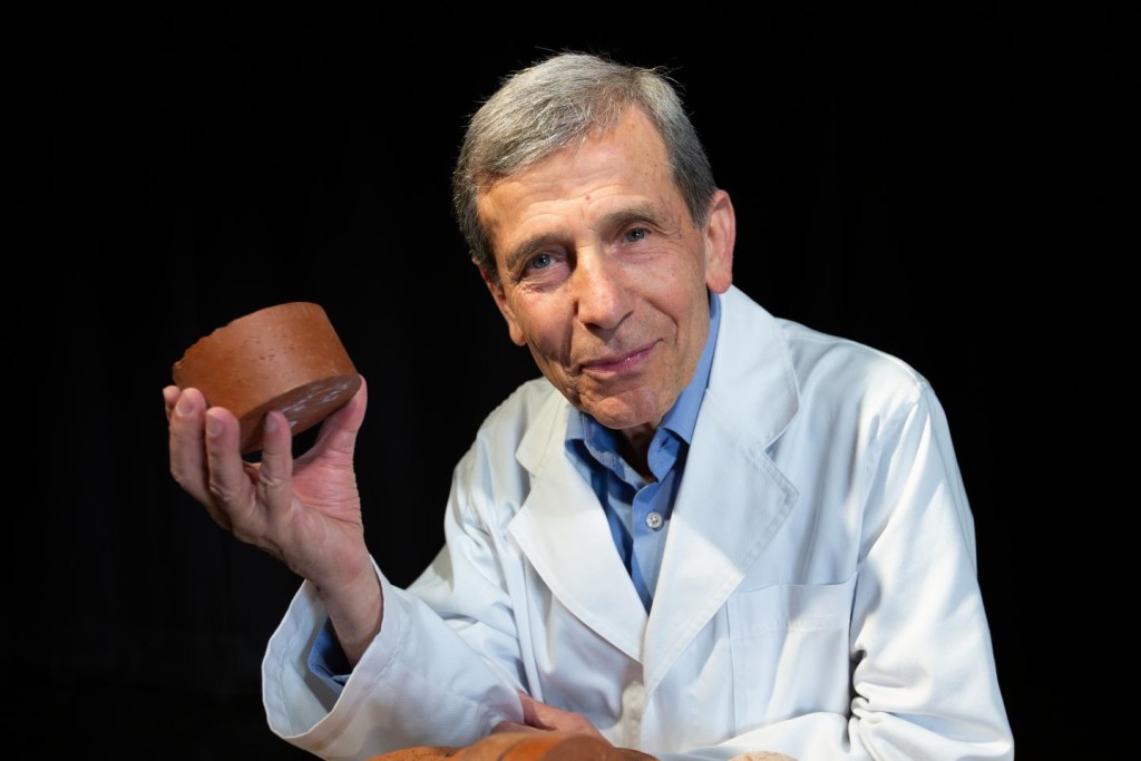 Associate Professor Abbas Mohajerani with a biosolids brick, [Credit: RMIT University]